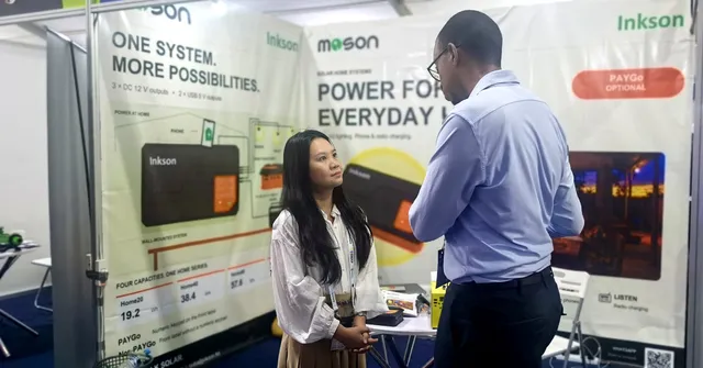 A member of the MOSON team in a meeting with a visitor at booth 32