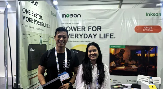 A visitor and a member of the MOSON team at booth 32
