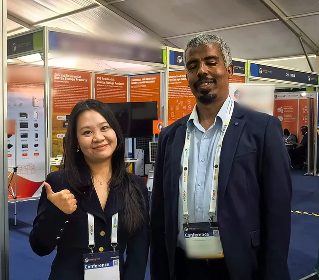 A member of the MOSON team giving a thumbs up next to a visitor at the expo
