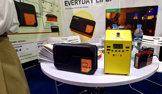 Solar home system samples on the table at booth 32: the H Series and a larger system from our X range, with radios